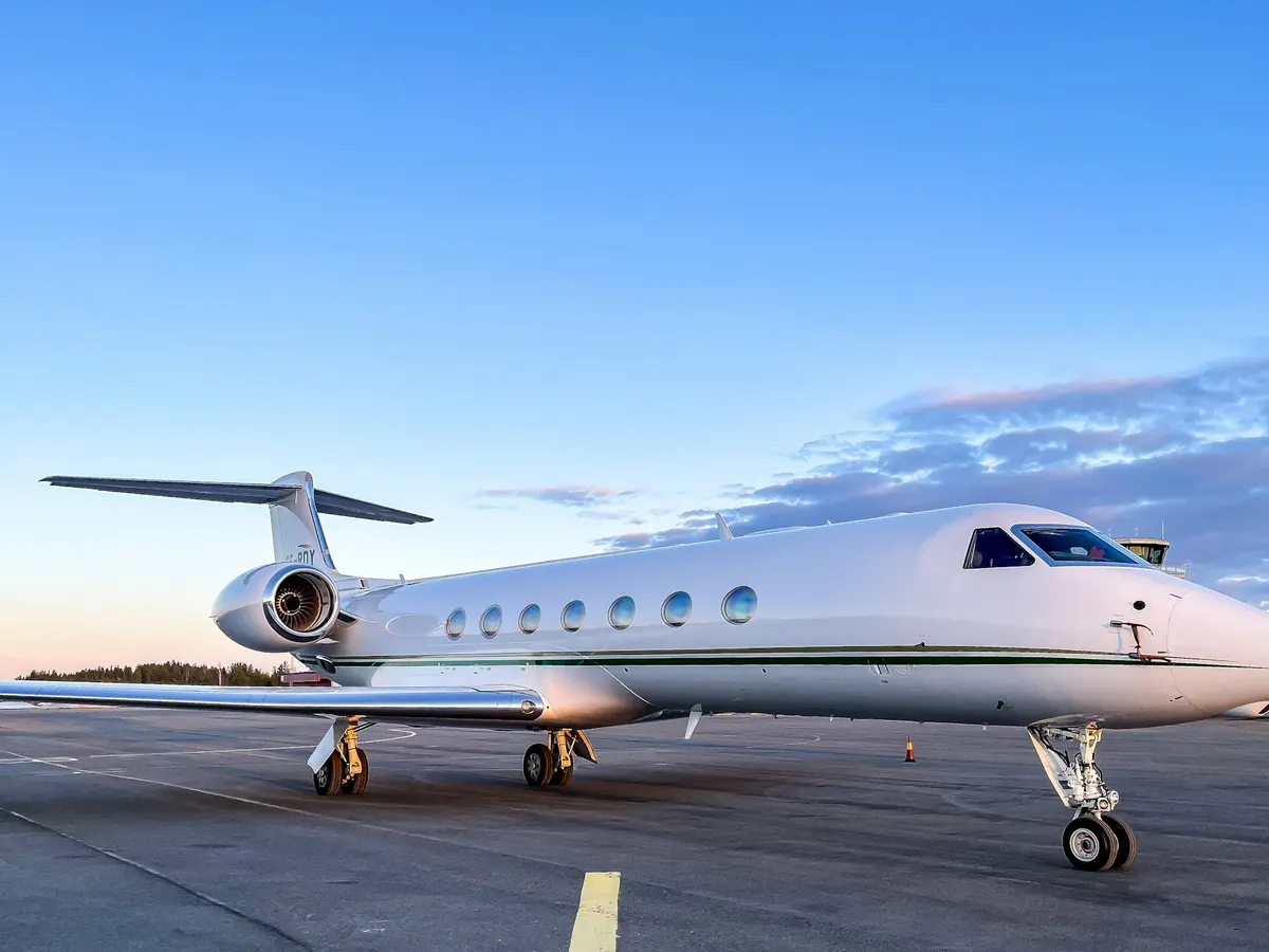 A large-cabin Gulfstream on the ramp under a clear sky