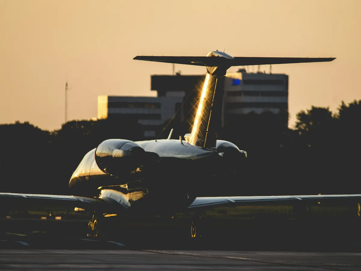 A business jet backlit by low evening sun