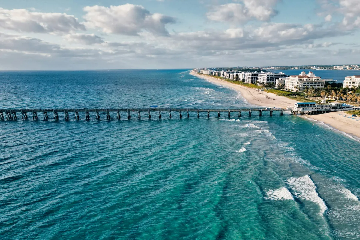 A pier reaching into turquoise water off Palm Beach